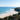 Pristine white sand beach and coastal luxury homes framed by lush greenery during a luxury stay at Byron Bay.