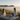 Two women enjoying a golden picnic overlooking Main Beach in Byron Bay in winter with calm ocean views and warm afternoon sunshine.
