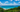 A breathtaking view of the turquoise ocean meeting the lush green coastline under a vibrant sky at byron bay