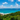 A breathtaking view of the turquoise ocean meeting the lush green coastline under a vibrant sky at byron bay