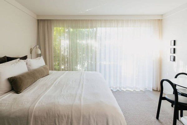 Junior King Plus bedroom with white linen bedding